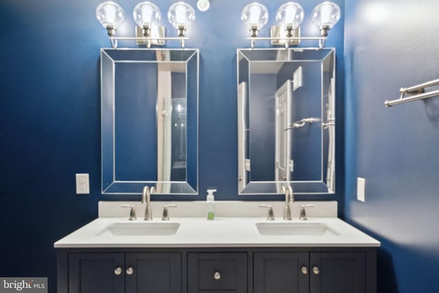 full bathroom featuring a sink and double vanity