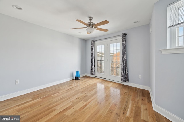 unfurnished room featuring light wood-style flooring, baseboards, and ceiling fan