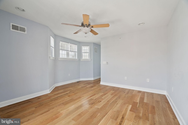 spare room with visible vents, baseboards, and light wood-style floors