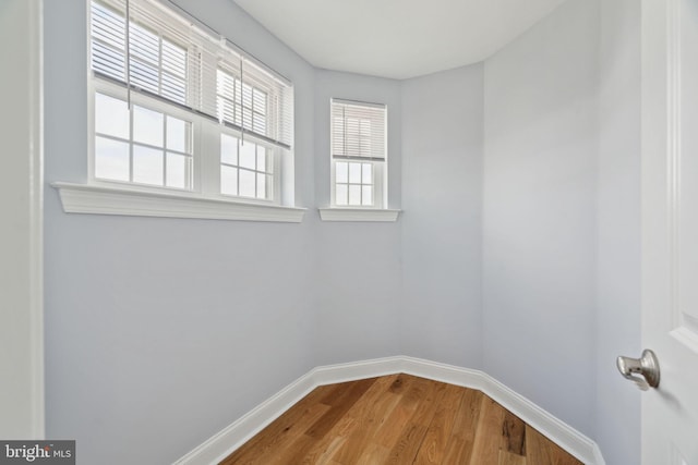 empty room with wood finished floors and baseboards