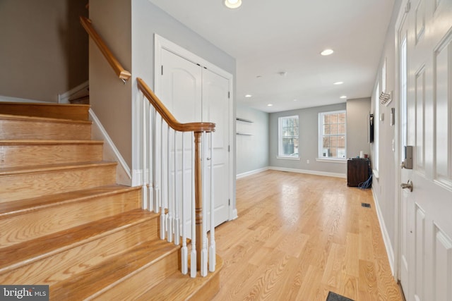 entrance foyer with stairs, recessed lighting, baseboards, and light wood finished floors