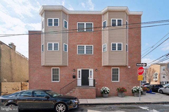 multi unit property featuring fence and brick siding