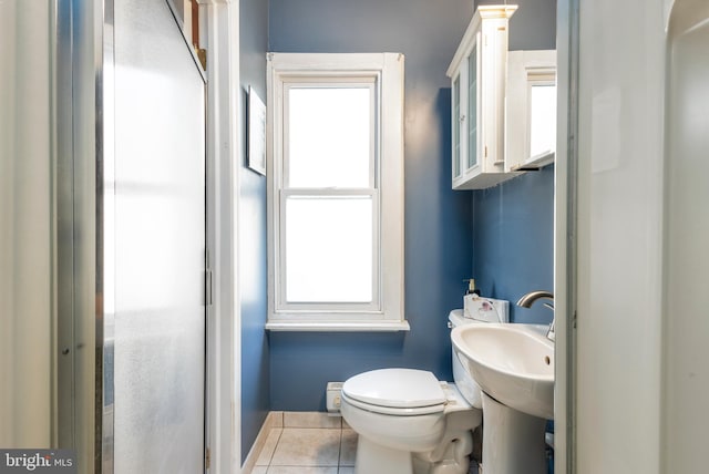 bathroom featuring tile patterned floors, plenty of natural light, and toilet