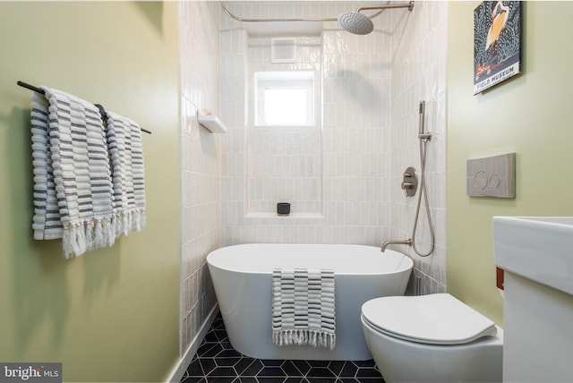 bathroom featuring tile patterned floors, tiled shower, toilet, and a freestanding bath