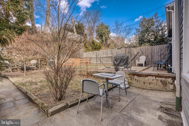 view of patio featuring fence