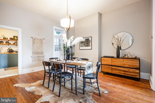 dining room with baseboards and wood-type flooring