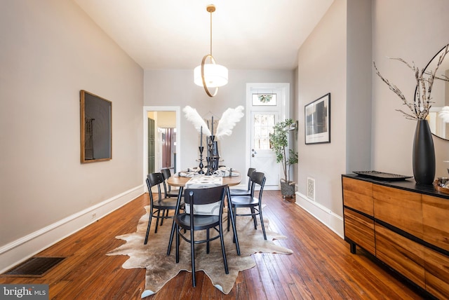 dining area with hardwood / wood-style floors, baseboards, and visible vents