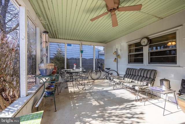 sunroom featuring plenty of natural light and a ceiling fan