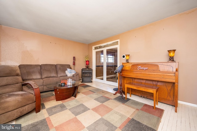 living area with baseboards and hardwood / wood-style flooring