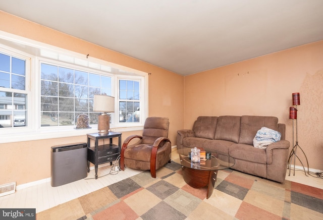 living room with baseboards and visible vents