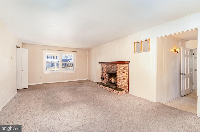 unfurnished living room featuring a fireplace and carpet floors