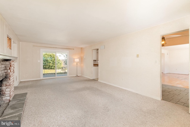 unfurnished living room featuring baseboards, light carpet, and a brick fireplace