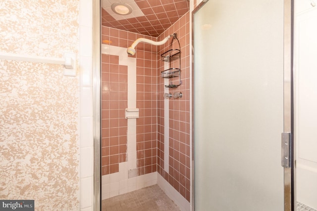 full bathroom with wallpapered walls and a stall shower