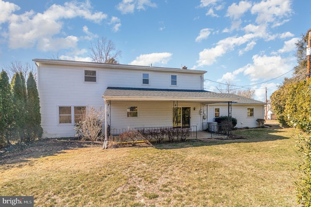 rear view of house featuring a patio area and a yard