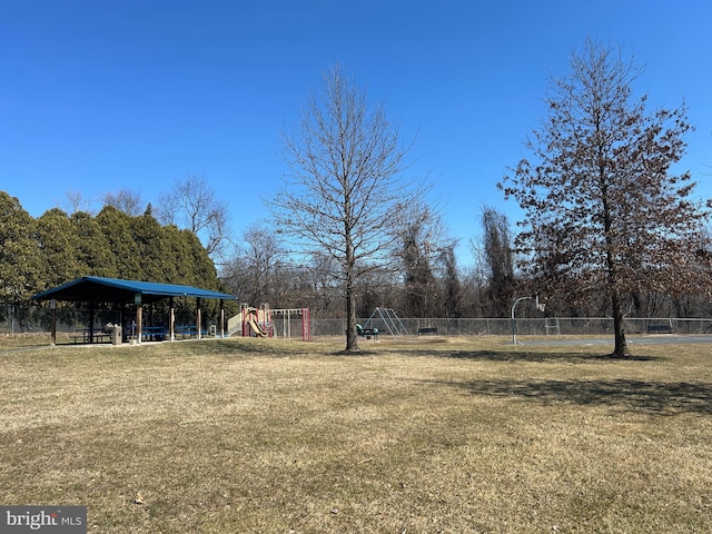 view of yard with playground community and fence