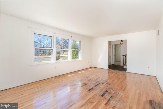 empty room with stairway and light wood-style flooring