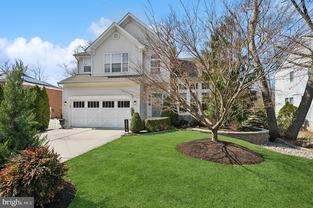 view of front facade with a front lawn, an attached garage, and driveway