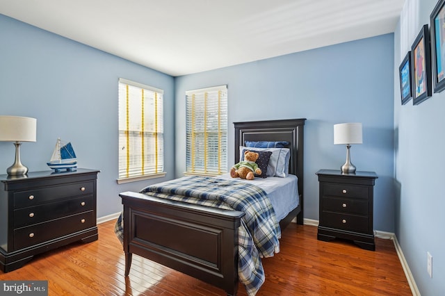 bedroom featuring baseboards and wood finished floors