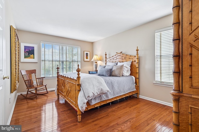 bedroom featuring baseboards and wood-type flooring