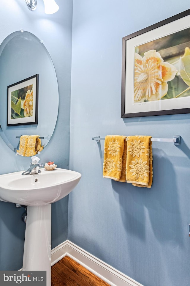 bathroom with wood finished floors and baseboards