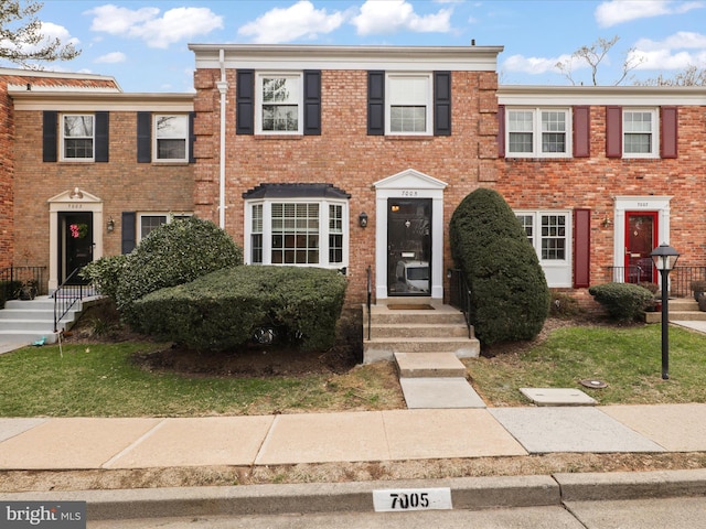 townhome / multi-family property with brick siding