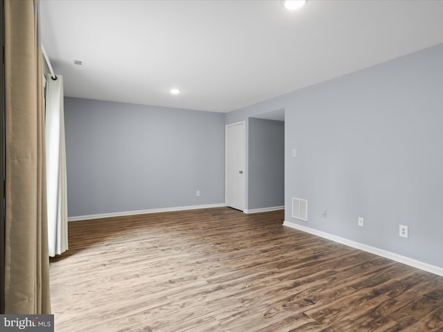 unfurnished room with recessed lighting, visible vents, baseboards, and wood finished floors