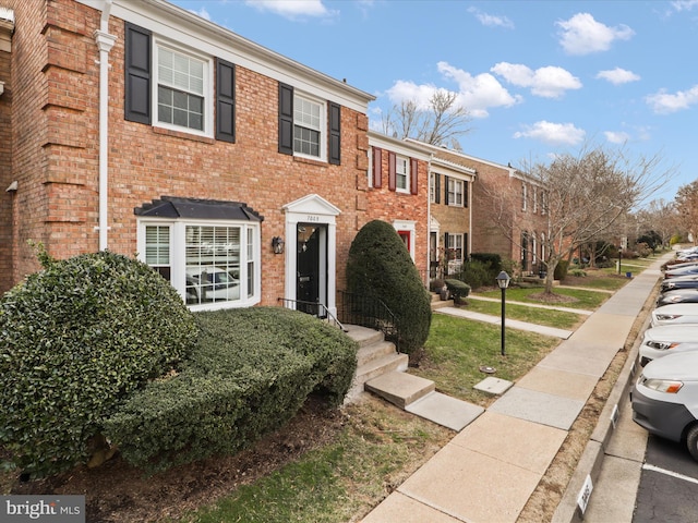 view of front of home with brick siding