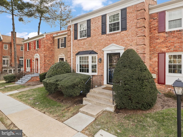 view of property with brick siding