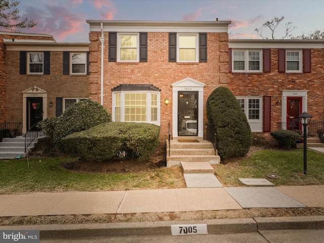 townhome / multi-family property featuring brick siding