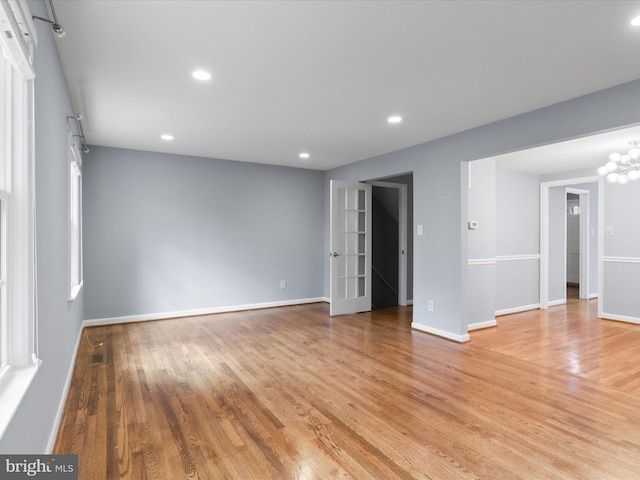 unfurnished room with recessed lighting, light wood-type flooring, baseboards, and visible vents