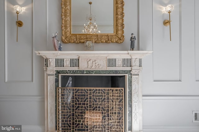 room details with visible vents and an inviting chandelier