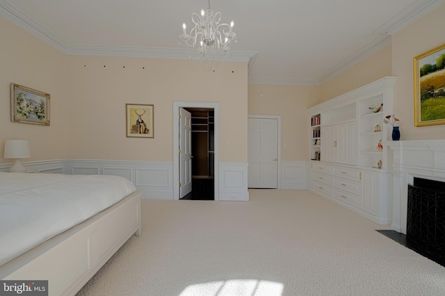 bedroom featuring a wainscoted wall, carpet floors, a fireplace with flush hearth, ornamental molding, and a decorative wall