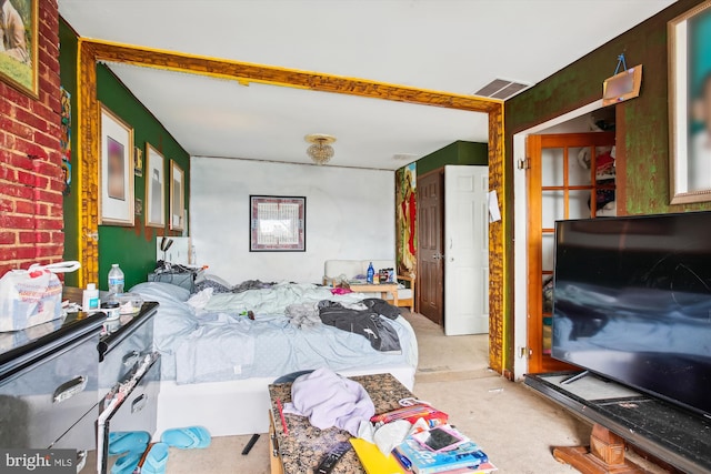 carpeted bedroom featuring visible vents