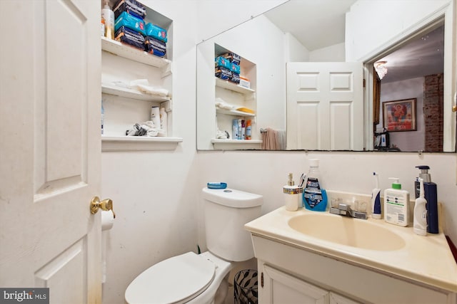 half bathroom with toilet and vanity