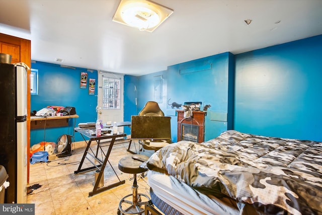 bedroom with freestanding refrigerator