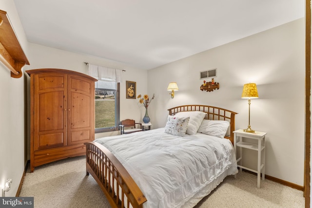 bedroom with light carpet, visible vents, and baseboards