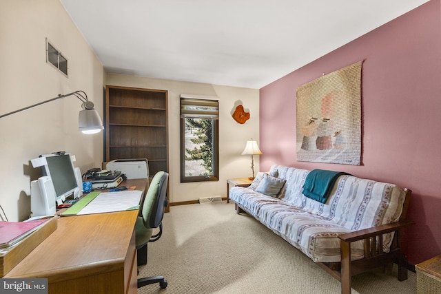 carpeted home office featuring visible vents and baseboards