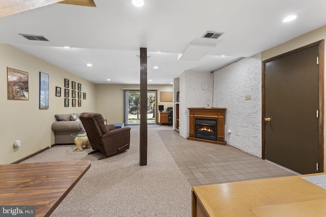 living room featuring light carpet, visible vents, recessed lighting, and a warm lit fireplace