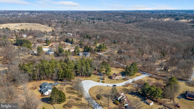 aerial view featuring a wooded view