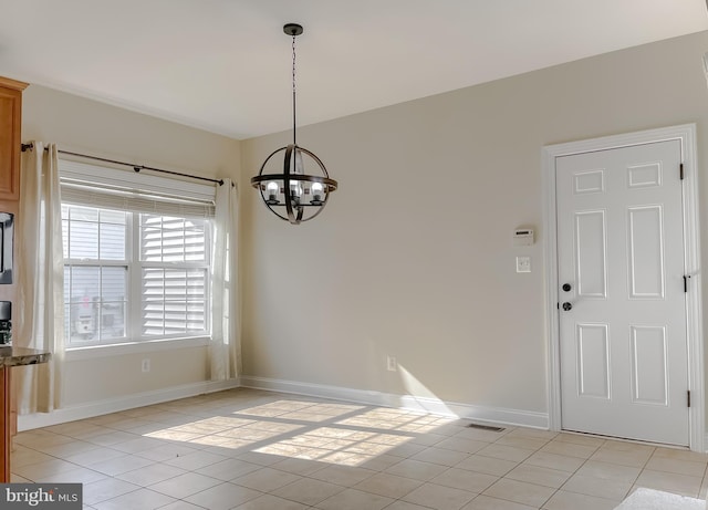 unfurnished dining area with baseboards, an inviting chandelier, and light tile patterned floors