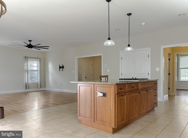 kitchen with plenty of natural light, baseboards, and ceiling fan