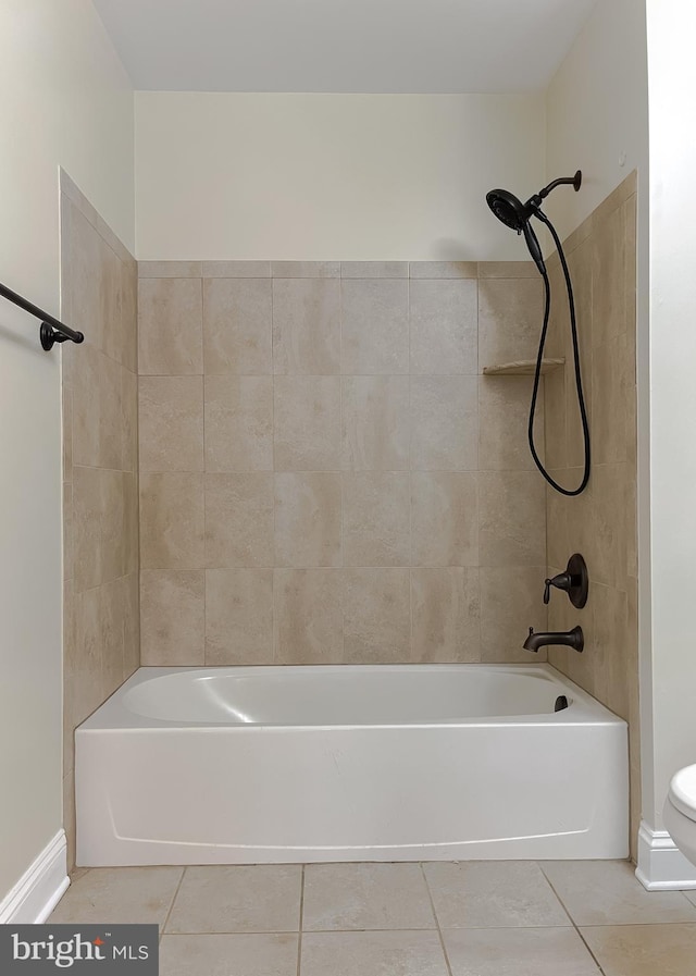 bathroom with tile patterned flooring, baseboards, toilet, and bathing tub / shower combination