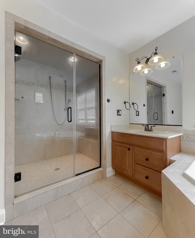 full bath featuring vanity, tile patterned flooring, a stall shower, and a bathtub