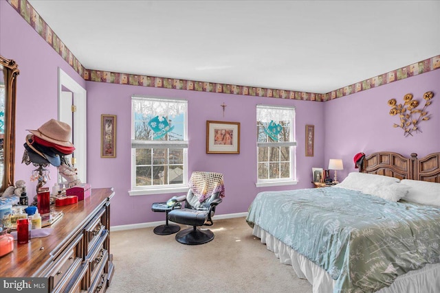 carpeted bedroom with multiple windows and baseboards