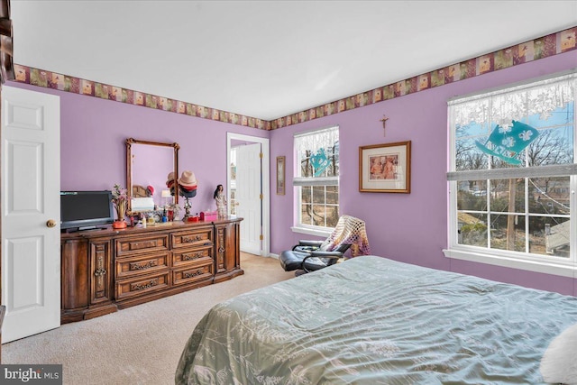 bedroom featuring carpet flooring and connected bathroom