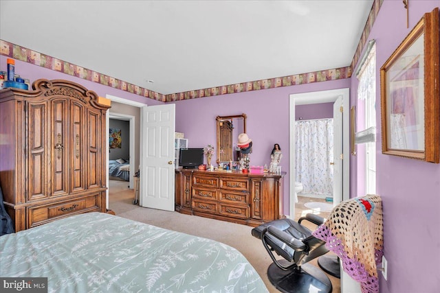 carpeted bedroom with ensuite bath