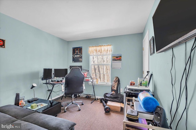 carpeted home office with baseboards