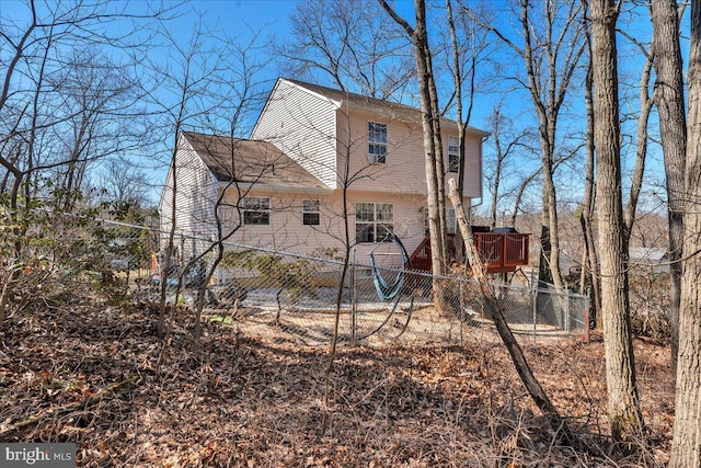 view of home's exterior with a wooden deck and fence