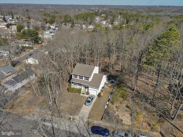 birds eye view of property with a view of trees