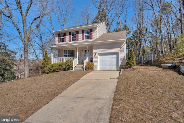 view of front of property with concrete driveway, an attached garage, and covered porch